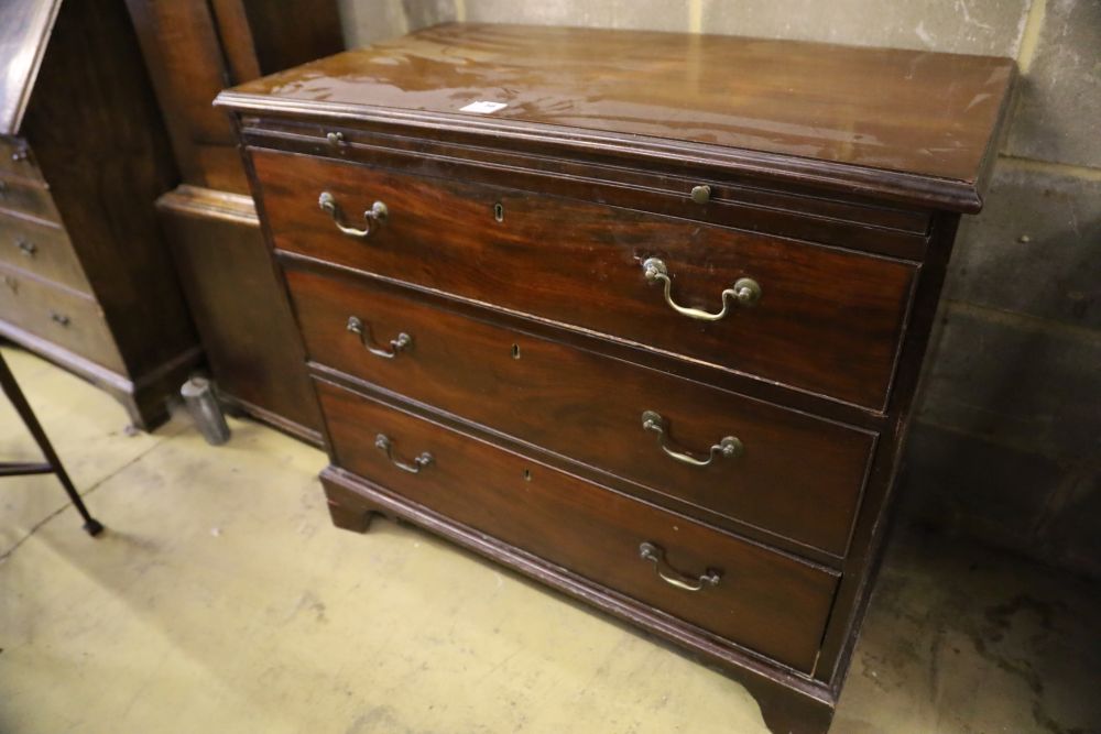 An Edwardian George III style mahogany chest, with brushing slide and three drawers, width 94cm